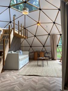 a bedroom in a tent with a bed and a staircase at Meselik Park Bungalov in Sapanca