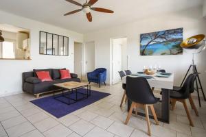 a living room with a couch and a table at Superb apartment with loggia and view on the sea - Hyères - Welkeys in Hyères