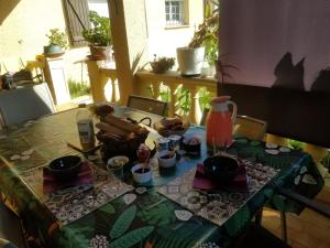 a table with a table cloth with food on it at Les Lauriers in Espondeilhan