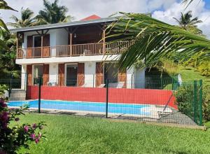 a house with a pool in front of it at La Passerelle 1 in Sainte-Rose