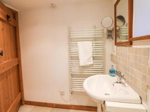 a bathroom with a sink and a shower at Lower Rissick Cottage in Penzance +11 photos