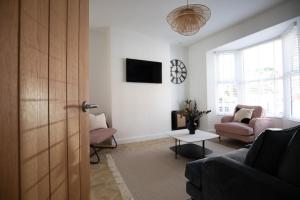 a living room with a couch and a table at Sea Renity in Whitby