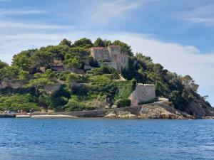 a castle on an island in the water at Bormes les Mimosas, Hameau de Cabasson, à 400m de la mer et du fort de Bregançon, Villa classée 3 étoiles, de 2 à 8 personnes in Bormes-les-Mimosas