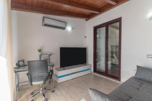 TV a/nebo společenská místnost v ubytování Casa Palau Sardegna
