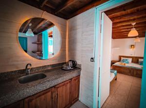 a bathroom with a sink and a mirror and a bed at Bamboo House Hotel Dahab in Dahab