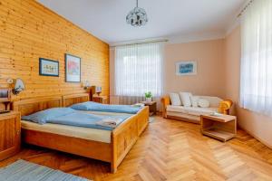 a bedroom with a bed and a couch at Bauernhof Woltron in Würflach