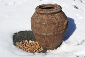 a brown vase sitting next to a pile of nuts at Die Stal in Sutherland +1 photo