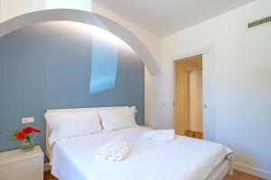 Posteľ alebo postele v izbe v ubytovaní Marinelli Apartments - La Meridiana