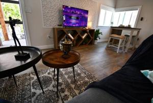 a living room with a couch and a tv at Shares View Luxury Apt in Rockledge