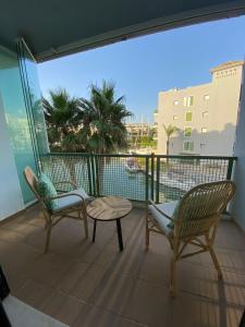 a balcony with two chairs and a table and a view at AIRE DE SOTOGRANDE in Sotogrande