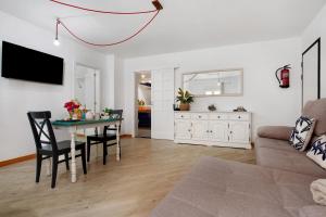 a living room with a table and a couch at Holidays Maxorata Relax in Gran Tarajal