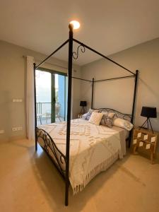 a bedroom with a canopy bed with a light on it at AIRE DE SOTOGRANDE in Sotogrande