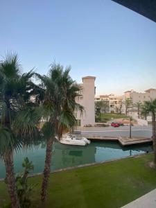 a view from the balcony of a resort with palm trees at AIRE DE SOTOGRANDE in Sotogrande
