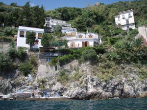 a house on a cliff next to the water at La Casetta di Marmorata - Ravello Accommodation in Ravello
