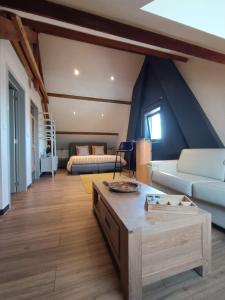 uma sala de estar com um sofá e uma cama em L 'Anima BB & table d'hôte em Helecine