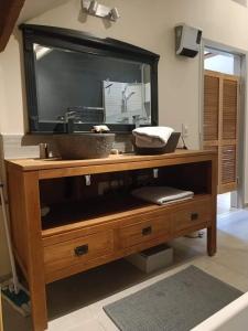 a television on a wooden stand with a bowl on it at L 'Anima BB & table d'hôte in Helecine