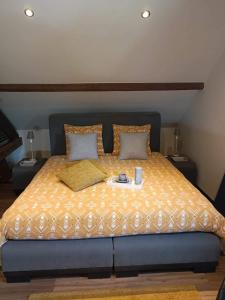 a bedroom with a bed with a yellow comforter at L 'Anima BB & table d'hôte in Helecine