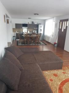 sala de estar con sofá y comedor en Cabana ''langa brad'' en Cavnic