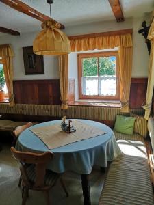 uma sala de estar com uma mesa e um sofá em Pension Schlager Taxerhof em Bad Hofgastein