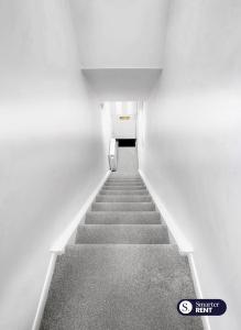 a stairway in a white room with a hallway at Maidenhead - 1 Bed Modern Flat - Private Entrance in Maidenhead