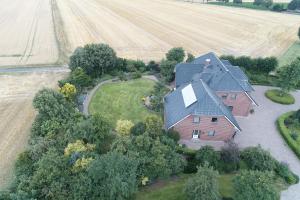 an aerial view of a house in front of a field at Gartentraum in Papenburg +10 photos