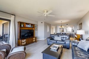 a living room with couches and a flat screen tv at Turtle Sea Dunes in Fernandina Beach
