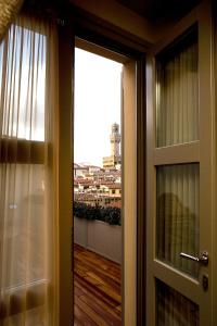 a door to a balcony with a view of a city at Hotel Balestri - WTB Hotels in Florence