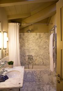a bathroom with a tub and a sink at Hotel Balestri - WTB Hotels in Florence