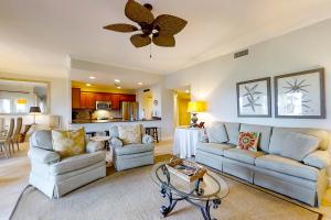 a living room with two couches and a table at Turtle Sea Dunes in Fernandina Beach