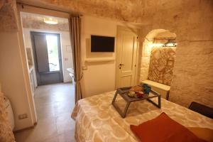 a bedroom with a bed with a table on it at ANTICO TRULLO 1831 in Locorotondo