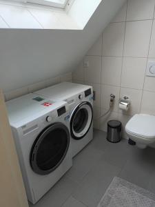 een wasmachine in een badkamer met een toilet bij ND Hotels & Apartments Bottrop am Centro in Bottrop
