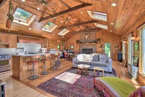 a kitchen and living room with a couch and a fireplace at Spacious Cheriton Home 8 Mi to Cape Charles! in Cape Charles