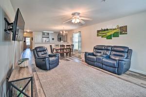 a living room with two couches and a tv at Myrtle Beach Condo with Screened Porch and Pool Access in Myrtle Beach