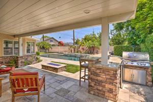 un patio extérieur avec un barbecue et une piscine dans l'établissement Quiet Anaheim Home with Pool, 5 Mi to Disney!, à Anaheim