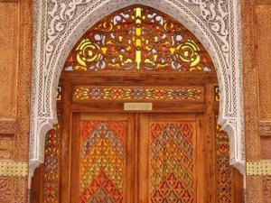 een houten deur met een glas-in-loodraam erboven bij Charming Riad Ouliya in Fs in Fès