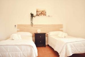 Postel nebo postele na pokoji v ubytování Il Casale dei Calanchi