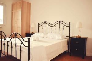 Postel nebo postele na pokoji v ubytování Il Casale dei Calanchi
