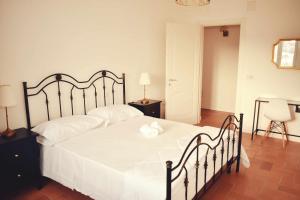 Postel nebo postele na pokoji v ubytování Il Casale dei Calanchi
