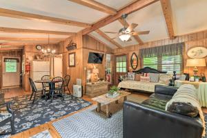 a living room with a couch and a table at Tranquil Creekside Cottage with Deck and Lanai in Franklin