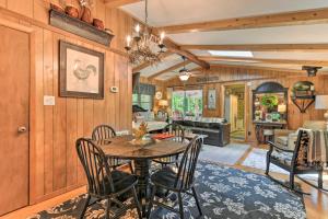 a dining room and living room with a table and chairs at Tranquil Creekside Cottage with Deck and Lanai in Franklin