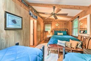 a bedroom with two beds and a ceiling fan at Tranquil Creekside Cottage with Deck and Lanai in Franklin