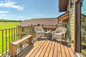 a wooden deck with chairs and a table on it at Duluth Studio with Fire Pit on Working Horse Farm! in Duluth