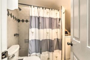 a bathroom with a shower curtain with a toilet at Brunswick Retreat Less Than 1 Mi to Potomac River! in Brunswick +19 photos