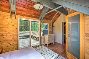 a bedroom with a bed and a balcony at Peaceful Wooded Cabin By Mt. Baker Ski Area! in Glacier