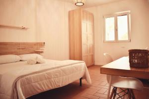 Postel nebo postele na pokoji v ubytování Il Casale dei Calanchi
