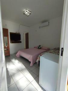 1 dormitorio con 1 cama y TV. en Lençóis Maranhenses - Ap 09 Porto dos Lençóis, en Barreirinhas