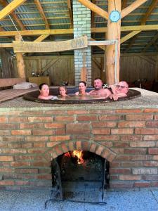 a group of people in a hot tub in a fireplace at Dům a Dům Živohošť in Živohošť