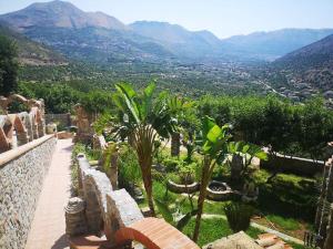 a view of a garden with mountains in the background at villa nonna nina in Capaci