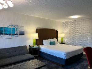 a hotel room with a bed and a couch at The Tide's Inn in Parksville