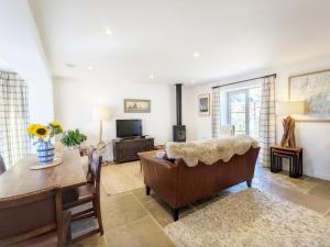 a living room with a couch and a table at Hearnesbrook Barn , Emsworth in Emsworth